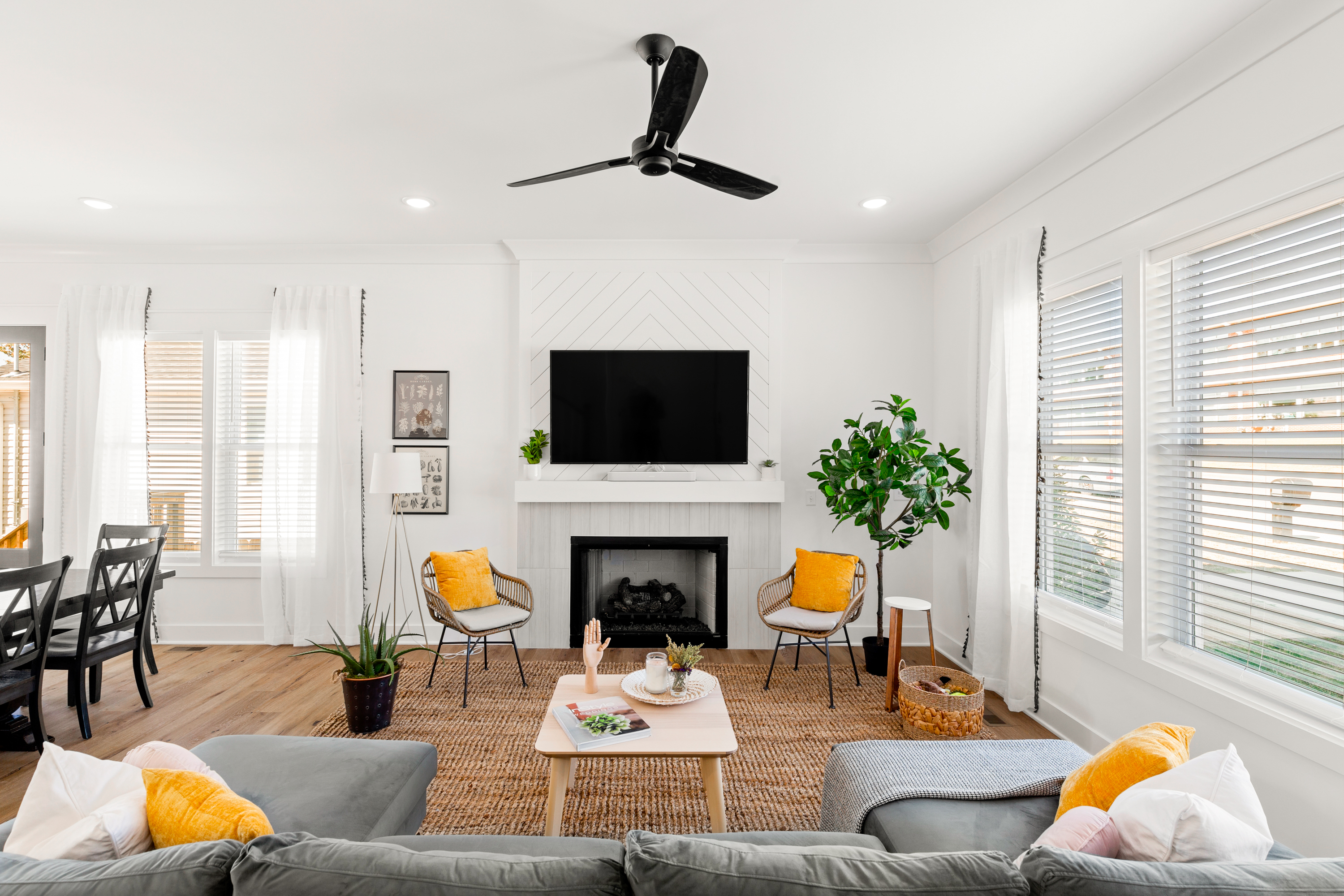 Bright living room with fireplace, modern decor, and large windows